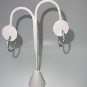 Women’s silver diamond studded hoops.